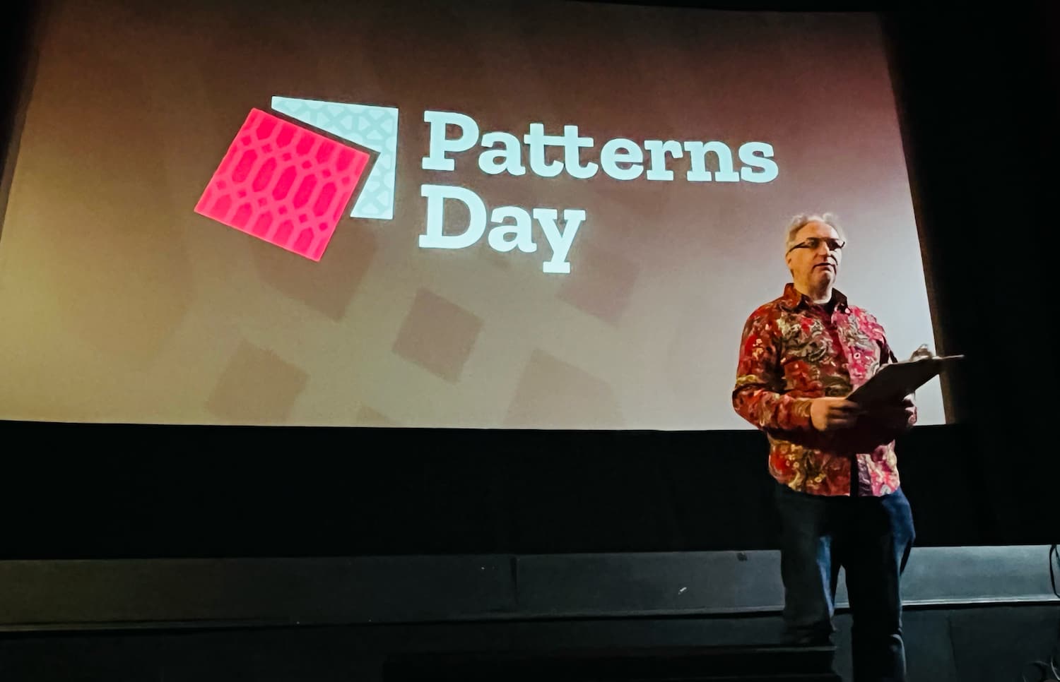 Jeremy presenting in front of the patterns day logo on screen